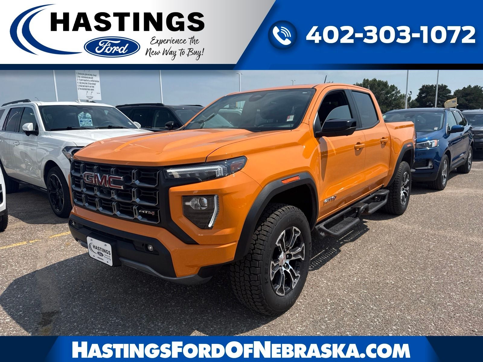 2025 GMC Canyon AT4 4SG in Desert Sun — front three-quarter view